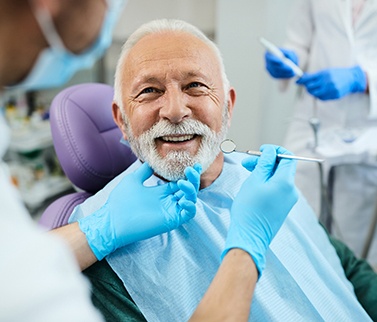 A man smiling at his dental appointment