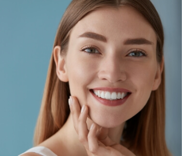 Woman with long brown hair smiling