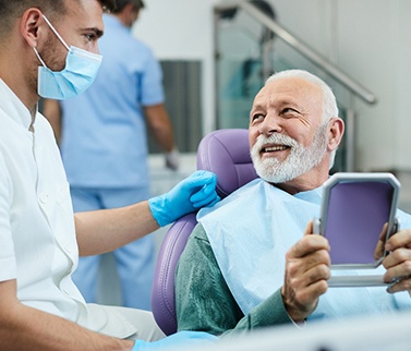 Senior patient talking with his dentist