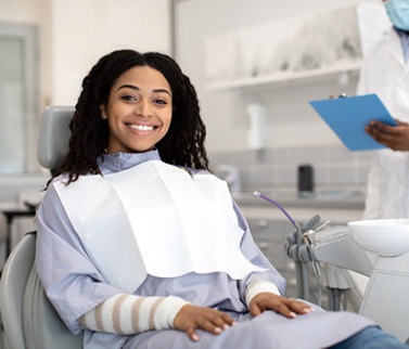 Woman smiling while sitting in treatment chair