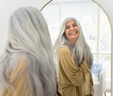 Older patient in Worcester smiling with dental implants at friends