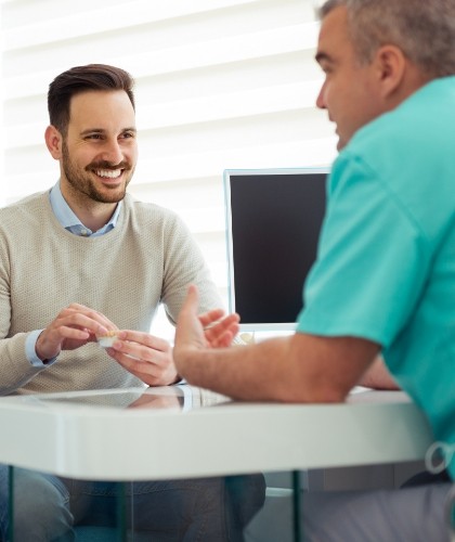 member of dental staff smiling with patient