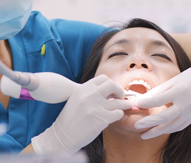 A woman getting scaling and root planing treatment