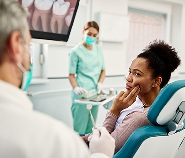 Man with glasses experiencing toothache