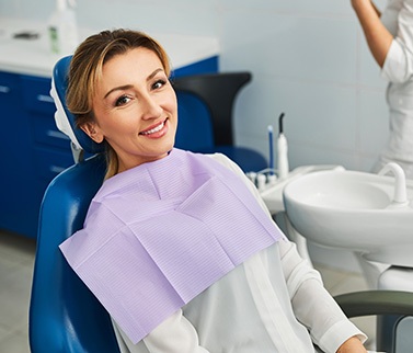 Woman smiling while sitting in treatment chair