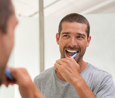 Patient in Worcester brushing after teeth whitening