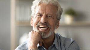 Man with dentures smiling
