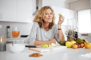 Woman eating at kitchen counter.